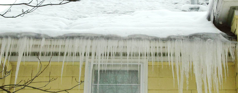 icicles and a forming ice dam on a roof